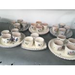 Six Poole Pottery egg cup sets.