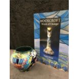 A small Moorcroft vase 4.5” high together with a “Moorcroft Winds of Change “ book.