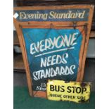 Two enamel signs : “Evening Standard” and “Bus Stop”.