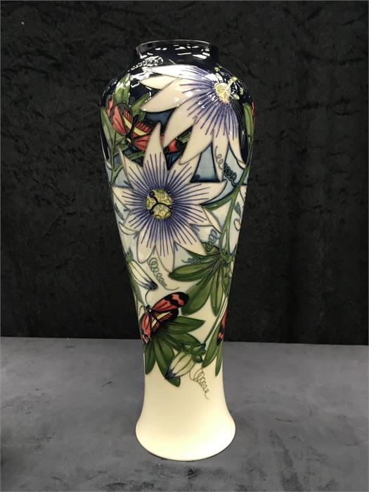 A large Moorcroft vase decorated with Passion flowers. (14.5” high).