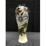 A large Moorcroft vase decorated with Passion flowers. (14.5” high).