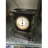 A black slate mantle clock.