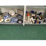 A large quantity of mixed china, glass, plates etc. on two shelves.