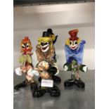 Four Murano glass clowns.