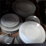 A box containing the residue of a dinner/tea service in white with silver coloured band together