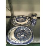 A quantity of blue and white Willow pattern china to include some early pieces.