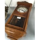 An oak cased chiming wall clock.