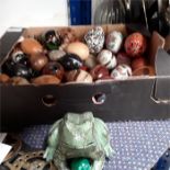 A metal frog ornament, pewter spoons and a large collection of assorted eggs.