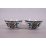 A pair of Chinese famille verte porcelain rice bowls decorated with fruiting vines and bats, 6