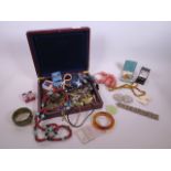 A quantity of costume jewellery, including a silver plated belt buckle, silver mounted amber pendant