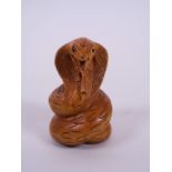 A Japanese carved hardwood netsuke in the form of a cobra, 2" long
