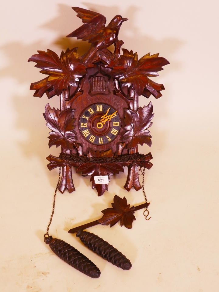 An early C20th Black Forest carved wood cuckoo clock, 18" high