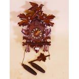 An early C20th Black Forest carved wood cuckoo clock, 18" high