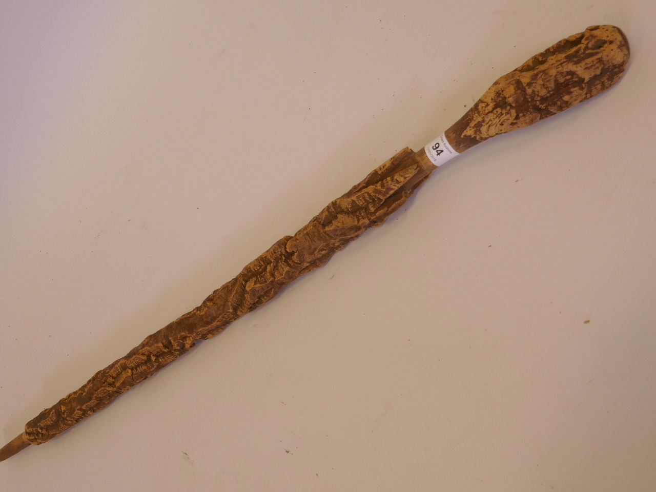 A carved cork walking stick, 34" long