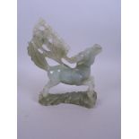A Chinese green hardstone carving of a mythical beast, A/F repair, 7½" high