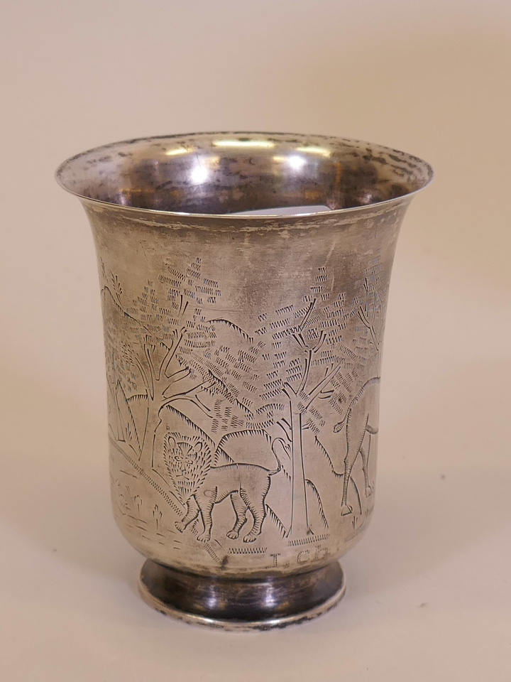 A C18th French silver beaker with engraved decoration of a lion, tiger, stag and a dancing man,