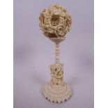 A Canton carved ivory puzzle ball on stand, 2" diameter