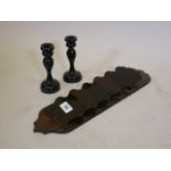 A Victorian coromandel letter rack, 17" long, and a pair of ebonised treen candlesticks