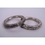 A pair of Oriental white metal bell bangles, 3" diameter