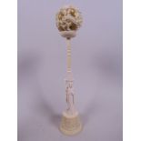 A Canton carved ivory puzzle ball on stand, 2" diameter