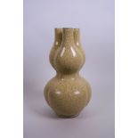A Chinese double gourd pottery vase with triple stem and yellow crackle glaze, raised seal mark to