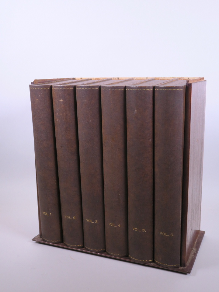 Six collectors' boxes in the form of books in a fitted mahogany cabinet, A/F