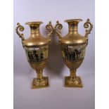 A pair of Empire style gilt porcelain urns decorated with panels depicting troops in a city