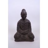 A Chinese bronze figure of Buddha with a gilt patina, 9" high
