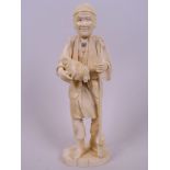 A Japanese carved ivory figurine of a woodsman with axe, holding a chicken in his arm, 7½" high