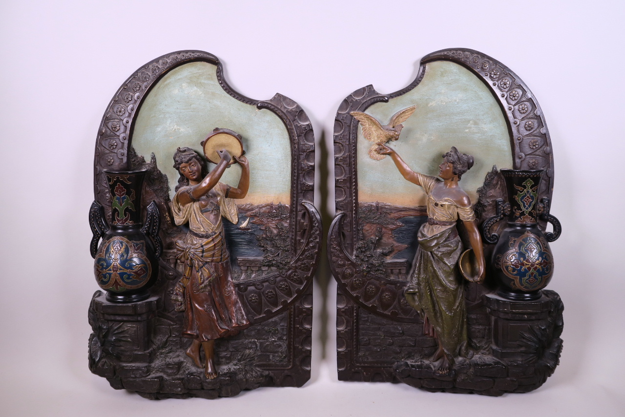 A pair of Johann Maresch terracotta wall plaques with raised decoration of Ottoman beauties, bears