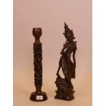 An Eastern hardwood table lamp carved with monkey decoration, and a Balinese carving of a dancer,