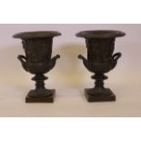 A pair of bronze Campagna style urns with raised classical decoration, after the antique, 12" high