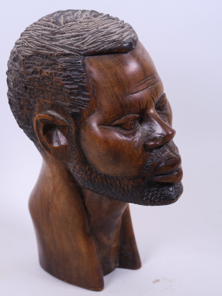 An African carved hardwood male head, 9" high