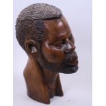 An African carved hardwood male head, 9" high