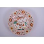 A Chinese polychrome porcelain dish decorated with boys playing board games, 6 character mark to