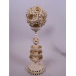 A Canton carved ivory puzzle ball on stand, 2½" diameter