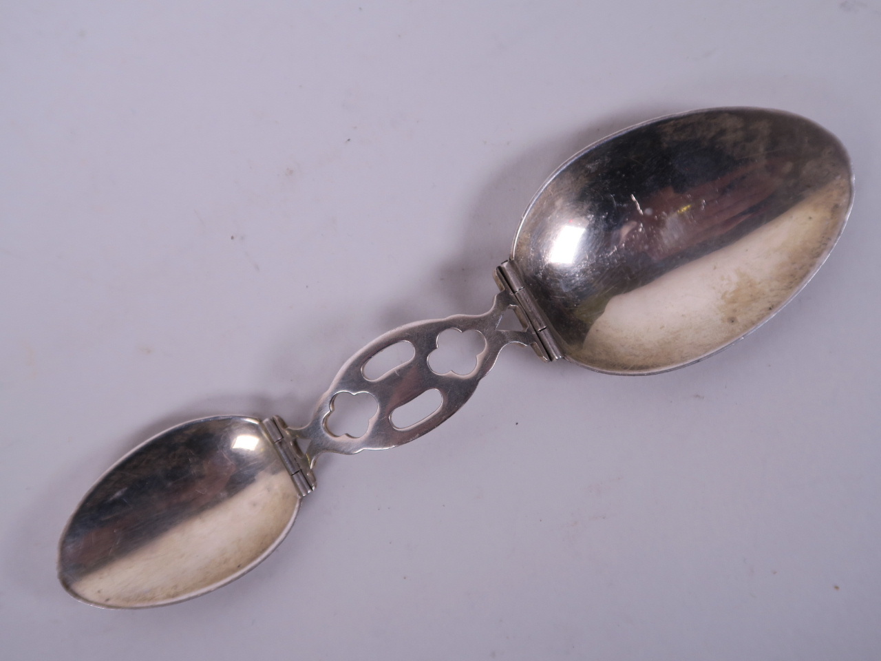 A folding silver two part doctor's spoon, 2½" long folded