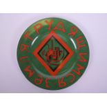 A porcelain cabinet plate with red and green Cyrillic script and Soviet style decoration, mark to