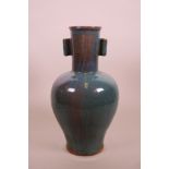 A Chinese pottery vase with twin lug handles and a Jun kiln style glaze, 12" high
