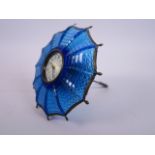 A pressed blue glass and brass mounted parasol clock with an enamel dial, 7" diameter