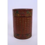 A Chinese red lacquer brush pot with inscribed and painted bat and character decoration, 6" high x