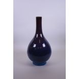 A Chinese mauve flambé glazed pottery bottle vase, seal mark to base, 14" high