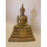 A large Thai Buddha with a gilt patina and set with semi precious stones, 39" high