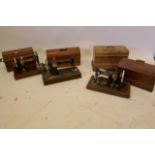 Four early C20th sewing machines and a 1930's oak canteen with part service contents