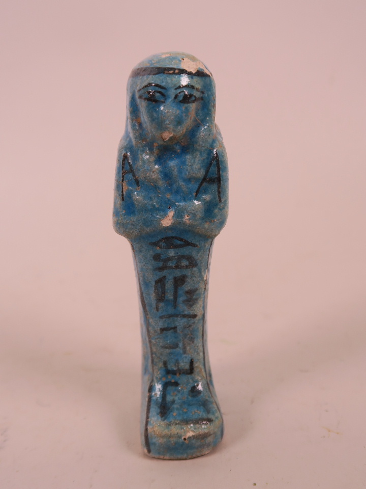 An Egyptian terracotta faience shabti with turquoise glaze, 4½" long