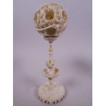 A Canton carved ivory puzzle ball on stand, 2" diameter