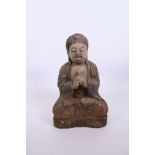 A Chinese carved and painted wood Buddha, 12" high