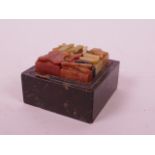 A C19th Chinese soapstone box containing an assortment of soapstone seal blanks with carved