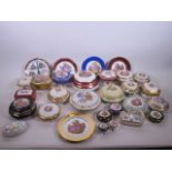 A large collection of Limoges porcelain trinket boxes and side plates, largest 6½" diameter, some