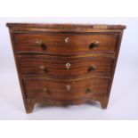 A small serpentine fronted apprentice chest of three graduated drawers crossbanded and veneered in